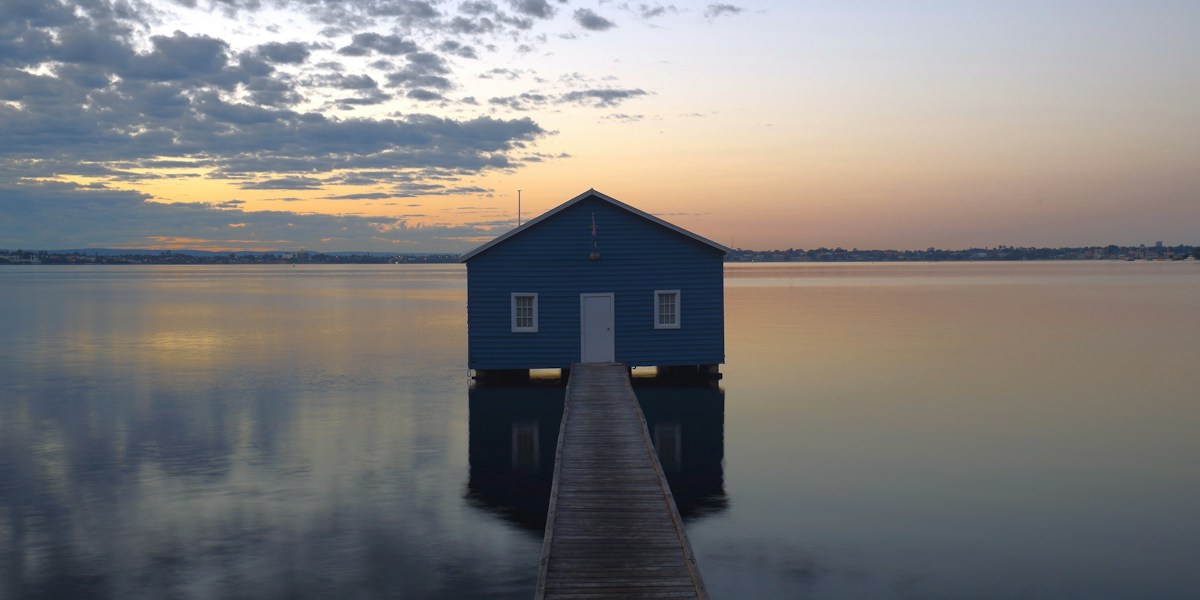 The blue boatshed on the Swan River in Perth at sunset